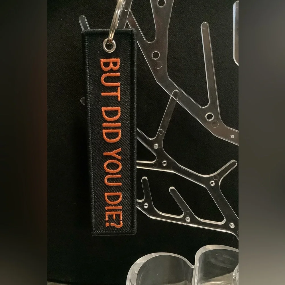Black Keychain with Orange Text